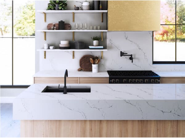 Minimalist kitchen featuring white marble countertops with subtle veining, black faucet fixtures, open shelving holding dishware, and large windows letting in natural light.