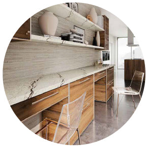 Modern workspace featuring a long marble countertop with subtle veining, wooden cabinets below, open shelves above, and transparent chairs on polished concrete flooring.