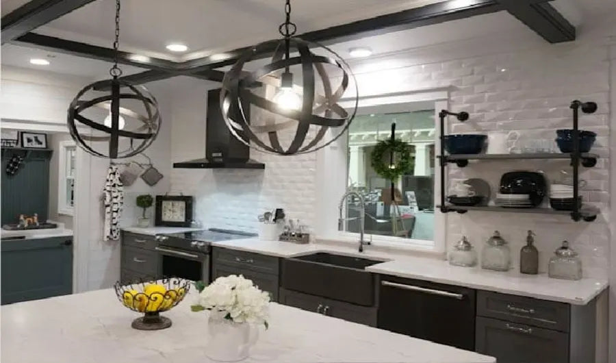 Spacious kitchen with dark cabinetry, white quartz countertops, industrial-style pendant lights, open shelving, and a farmhouse sink with a window view.