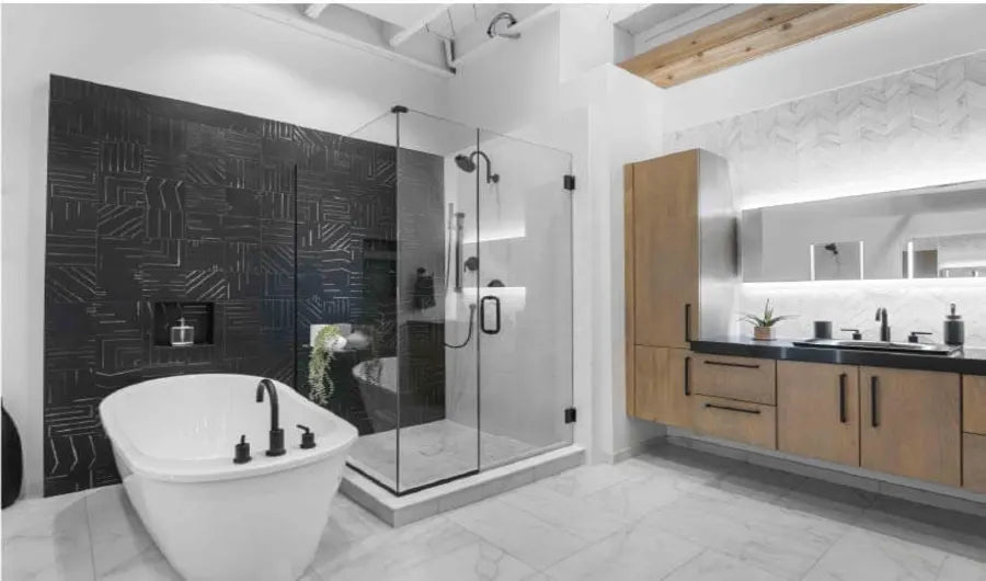 Modern bathroom with a freestanding white bathtub, glass-enclosed shower featuring black fixtures, and a wooden vanity with an illuminated mirror above.