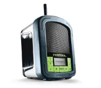 Compact portable radio with a black speaker grille and green control buttons, designed for use in a workshop or home improvement setting.