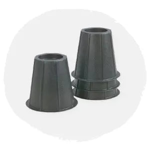 Two black tapered plastic furniture risers with a textured surface, shown on a neutral light background.