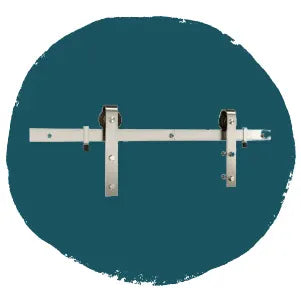White metal barn door hardware with two roller brackets and a mounting rail displayed on a dark teal circular background.