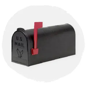 Classic black metal mailbox with a red flag raised on the side, featuring embossed U.S. Mail text and eagle emblem on the front, displayed on a soft neutral background.