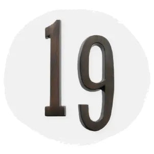 Dark metal house numbers one and nine displayed on a soft light circular background, suitable for home improvement or exterior identification.