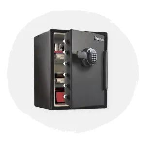 Black home safe with an electronic keypad lock partially open, showing organized contents inside against a plain background.