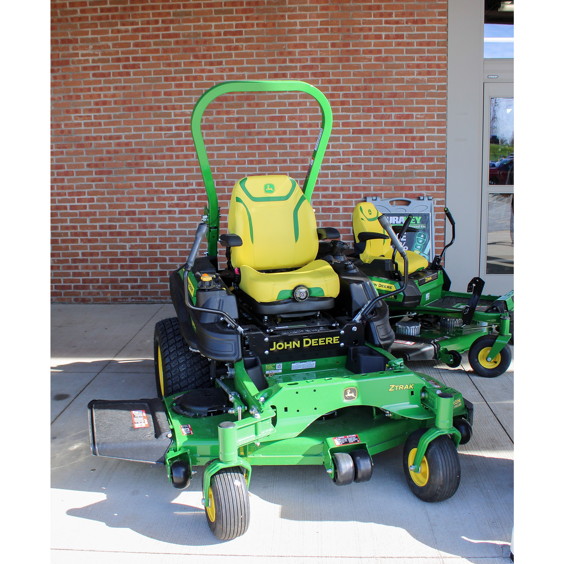 Green John Deere zero turn mower with yellow seat and 60-inch deck, displayed outdoors at Hartville Hardware in the lawn mowers and zero turn lawn mowers section.