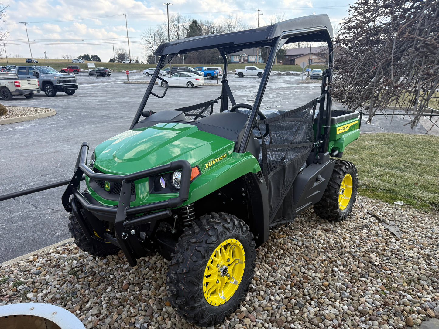 Green and yellow mid-size utility vehicle designed for rugged trails, part of John Deere Products, UTVs, and Mid-Size Series Utility Vehicles collections at Hartville Hardware.