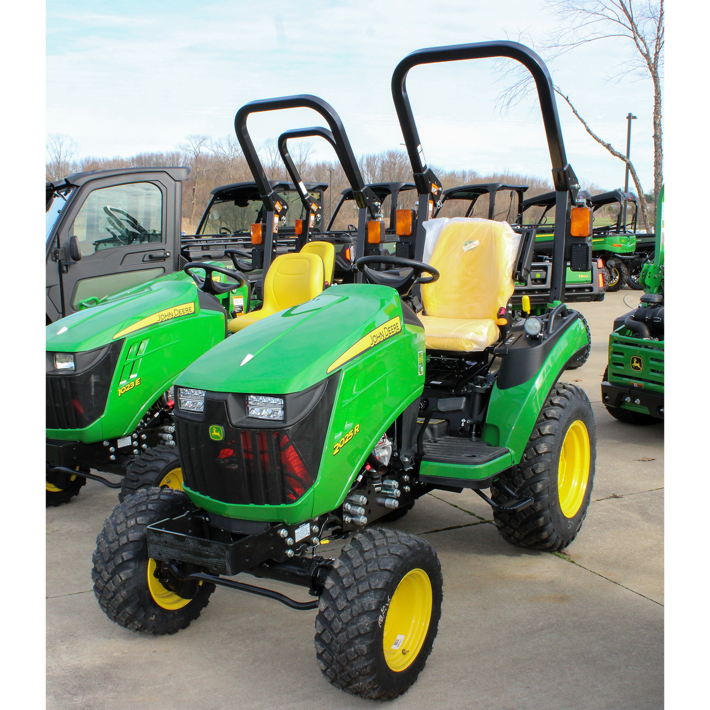 Green compact tractor with yellow seat and rollover protection, designed for efficient outdoor power tasks in lawn and garden and shop equipment collections.
