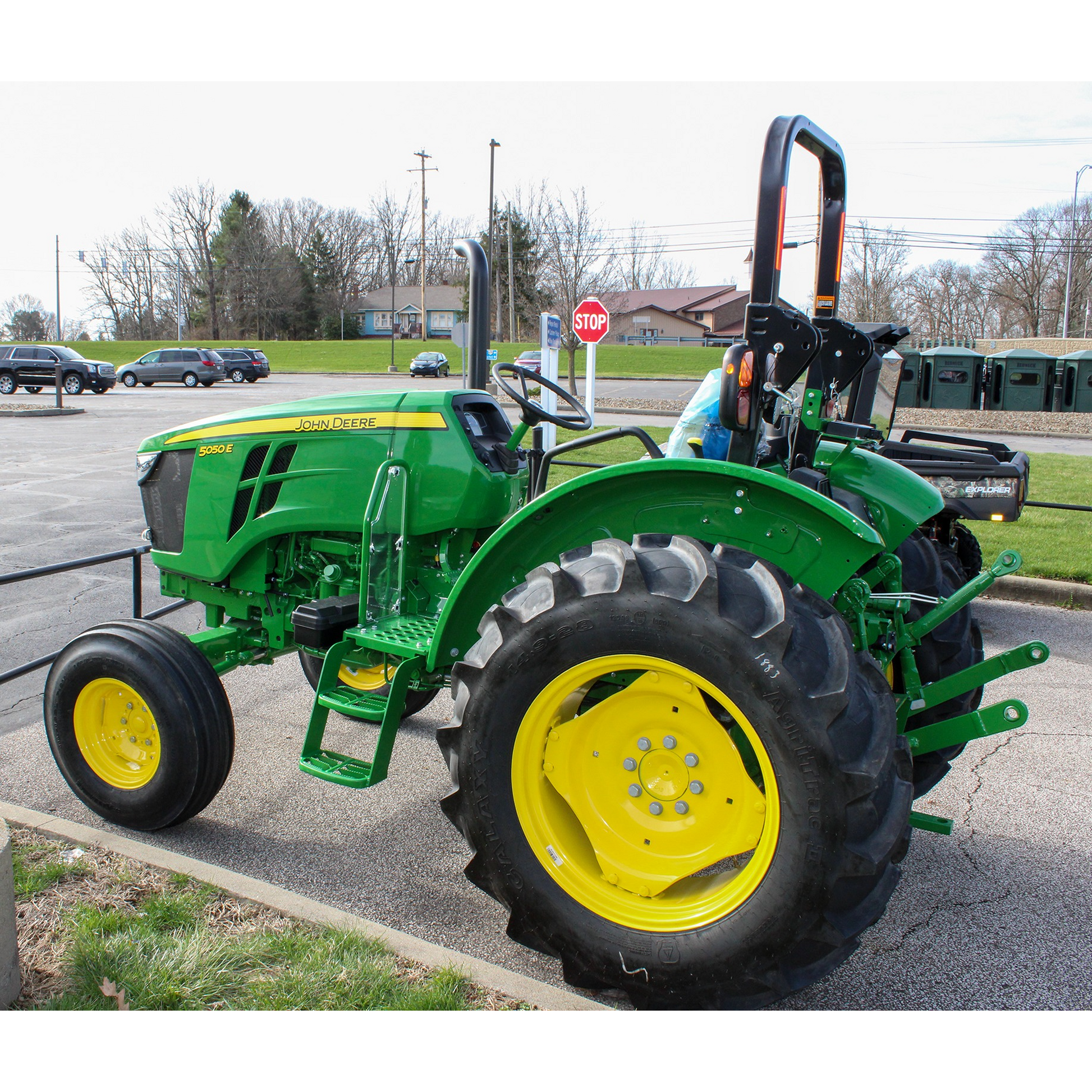 Green John Deere 5050E compact tractor with yellow wheels parked outdoors, featured in the outdoor power equipment and lawn & garden section at Hartville Hardware.