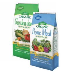 Two bags of organic gardening amendments, one labeled Garden-tone with vegetables and the other Bone Meal with flowers, both for soil enrichment.