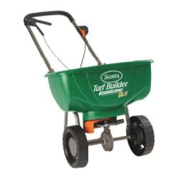 Green Scotts Turf Builder fertilizer spreader with black handle and wheels designed for lawn care and home improvement tasks.