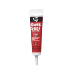 Tube of red and white Kwik Seal caulking sealant with a white nozzle, standing upright on a plain white background.