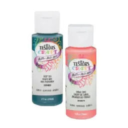 Two small bottles of craft paint, one in white and the other in coral pink, with colorful labels and white flip-top caps.