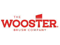 Red and white logo for The Wooster Brush Company featuring bold lettering with a stylized brush stroke above the 
