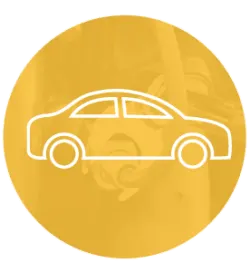 Simplified white line icon of a sedan car displayed over a warm yellow circular background with subtle mechanical parts in soft focus.