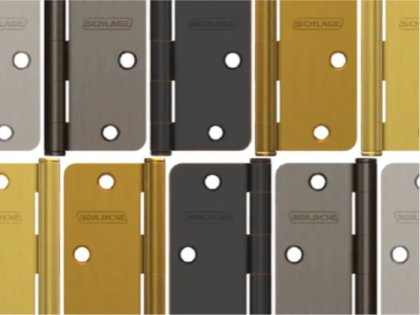 Assortment of metal door hinges in various finishes including brass, black, and brushed nickel, arranged in a grid pattern.