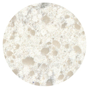 Close-up view of a light, creamy surface with scattered soft beige speckles and a slightly textured stone-like appearance.