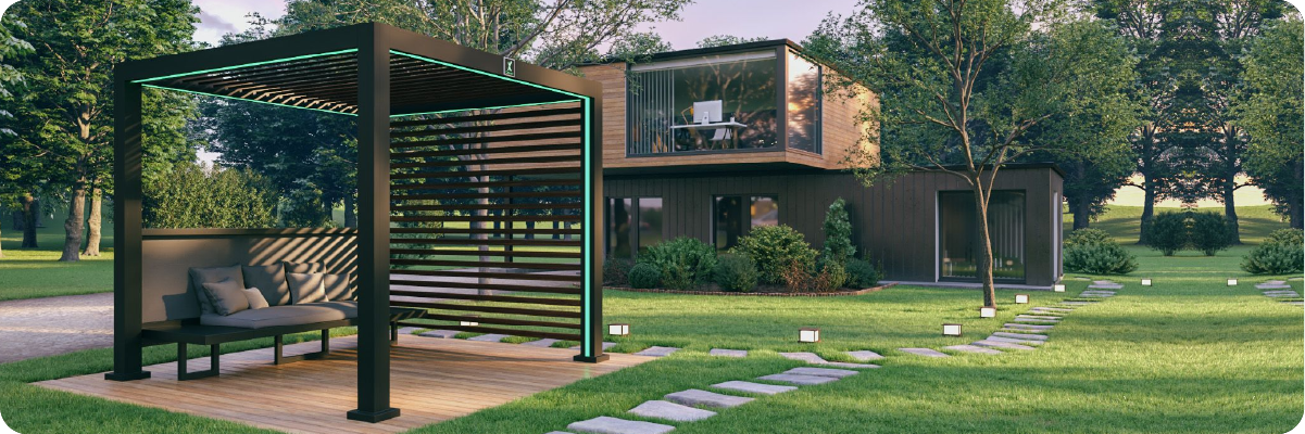 Modern backyard featuring a sleek pergola with adjustable slats, outdoor seating on a wooden deck, and a contemporary two-story house surrounded by greenery and stepping stones through the lawn.
