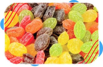 Close-up view of colorful assorted hard candy pieces in red, green, yellow, orange, and dark brown shades arranged together.