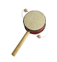 Small handheld wooden drum with a round beige drumhead and two attached beads that strike the surface when rotated.