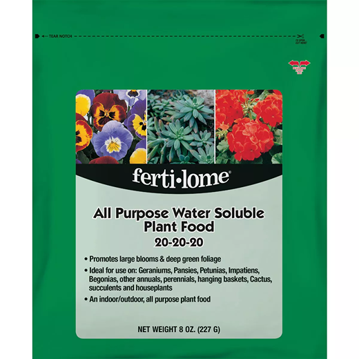 Green package of dry plant food promoting blooms and foliage for indoor and outdoor plants in lawn and garden care collections