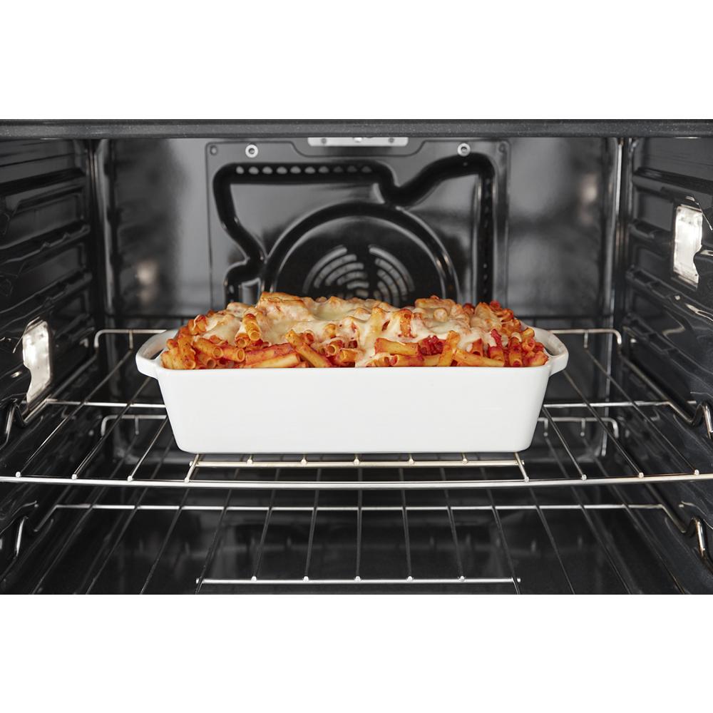 Baked pasta casserole in white dish cooking inside a smart single wall oven in Kitchen & Kitchenware collection