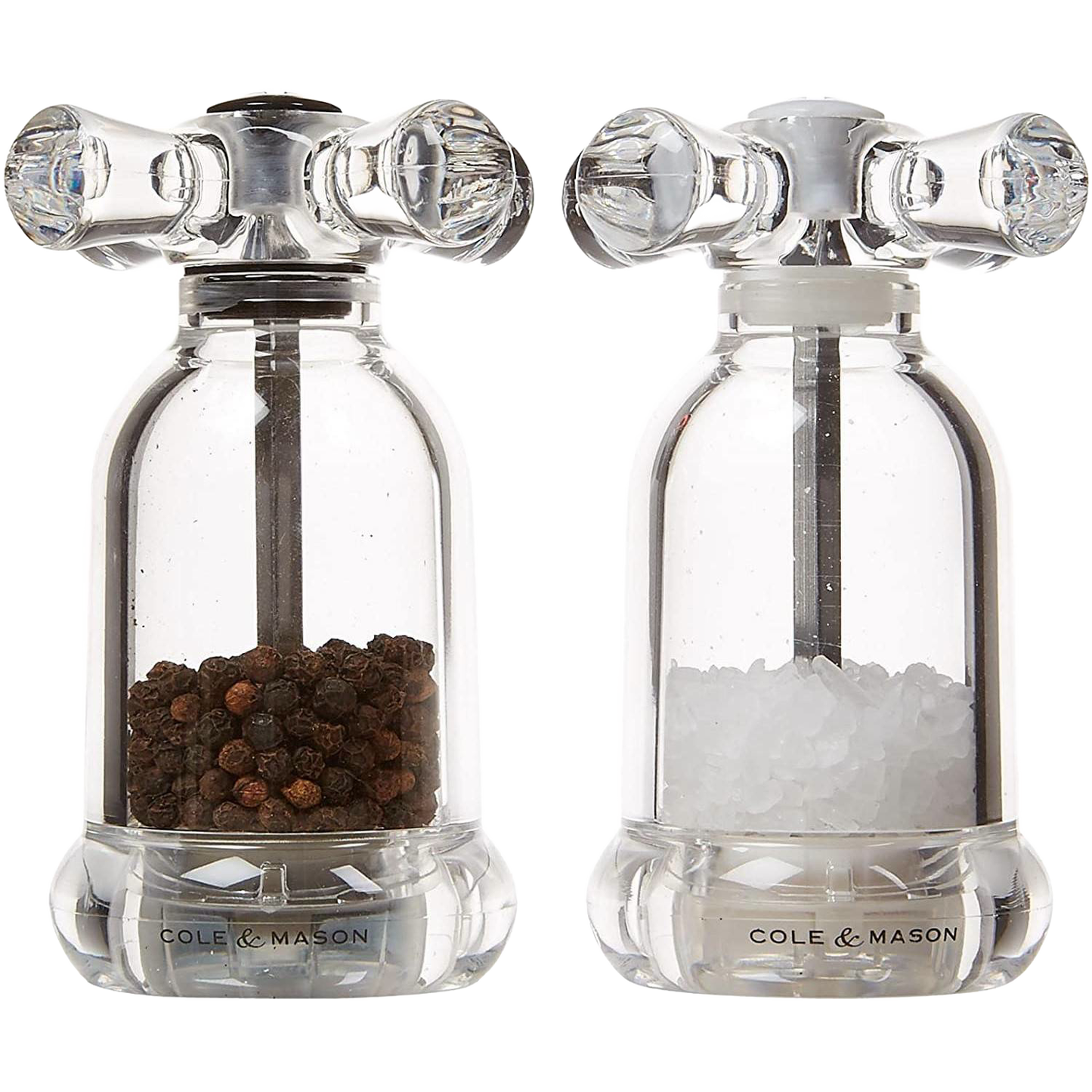Clear acrylic salt and pepper mills filled with black peppercorns and coarse salt in Kitchenware collection
