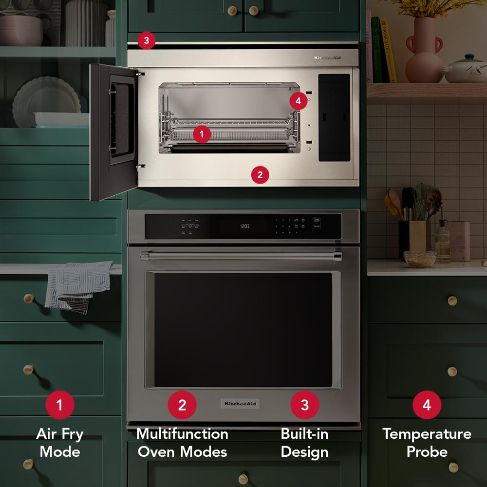 Built-in stainless steel convection microwave with air fry mode, multifunction oven features, and temperature probe in green kitchen.