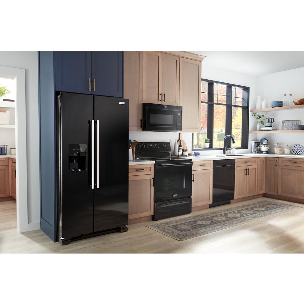 Black built-in microwave above black electric range in bright kitchen with wood cabinets and appliances collection