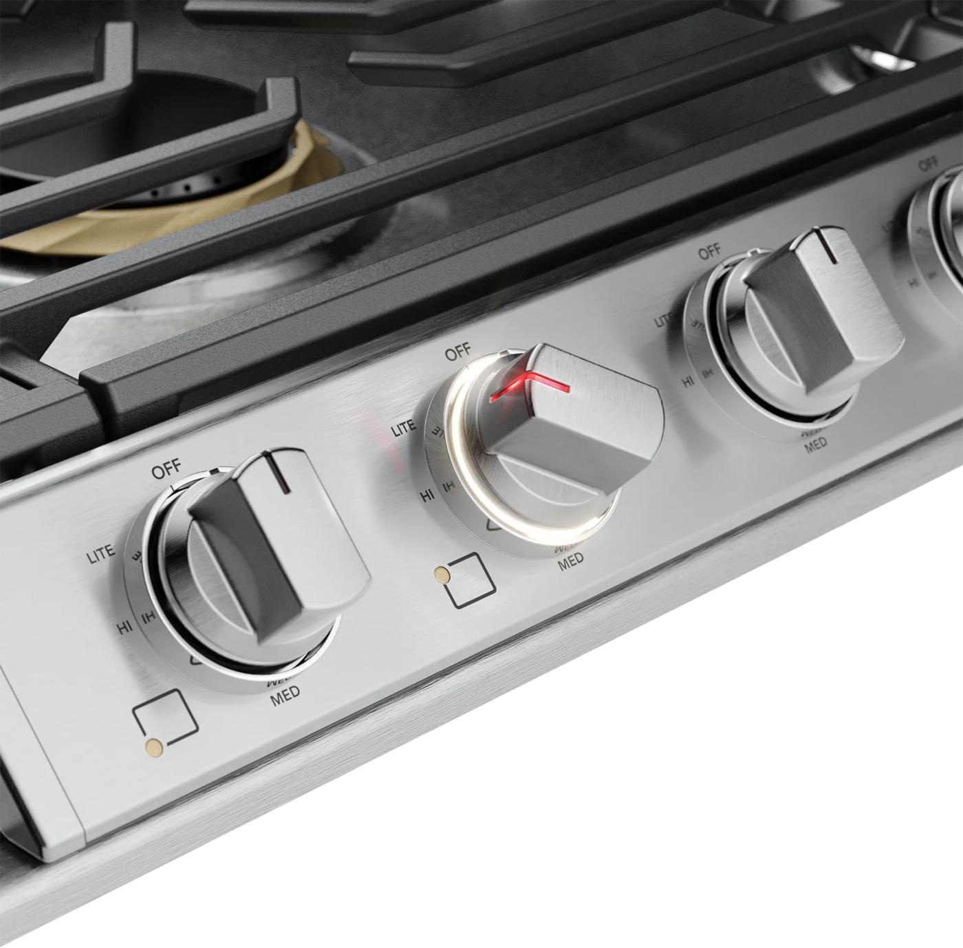 Close-up of stainless steel cooktop knobs with backlit LED indicators in kitchen appliances and cooktops collection