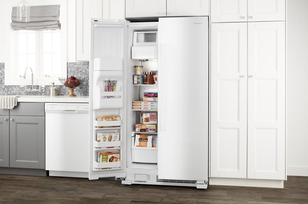 White 33-inch side-by-side refrigerator with interior shelves stocked with food in Kitchen & Appliances collections