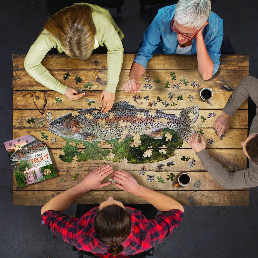Four people assembling Madd Capp I Am Trout Puzzle, 300-piece fish-shaped jigsaw from Toys & Games and Puzzles collections