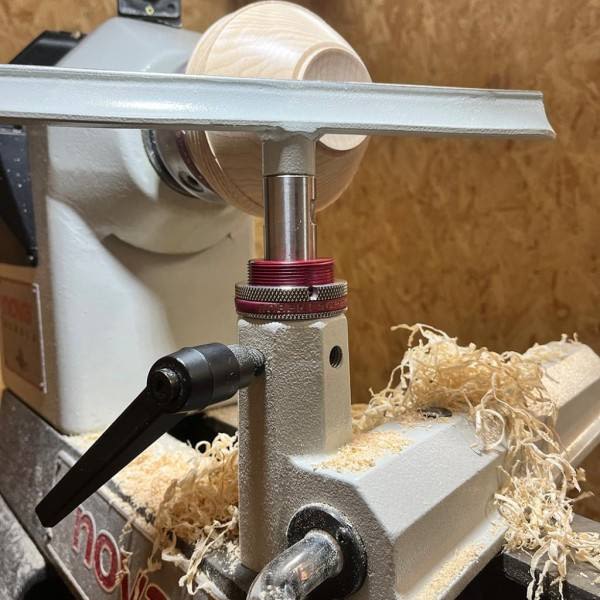 Wood lathe tool rest with red adjustment collar and black locking handle for woodworking tools and home improvement collections
