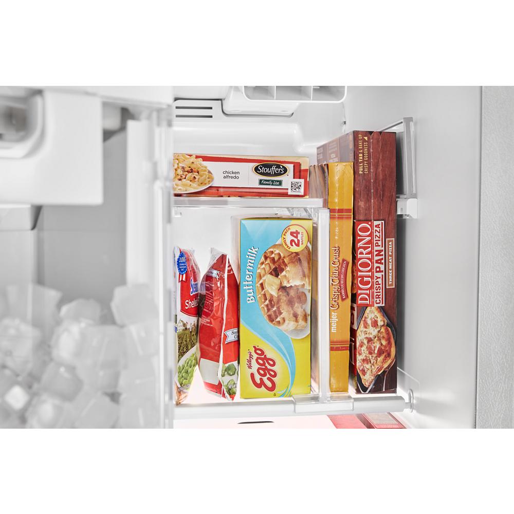 Inside view of a 36-inch side-by-side refrigerator storing frozen meals and pizza in the freezer compartment