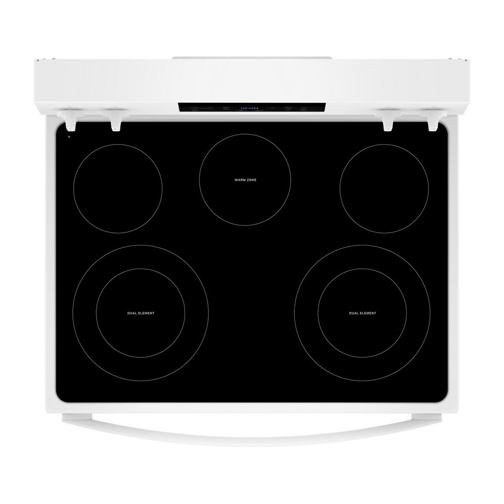 top view of white electric range with smooth black glass cooktop and five heating elements in kitchen appliances collection