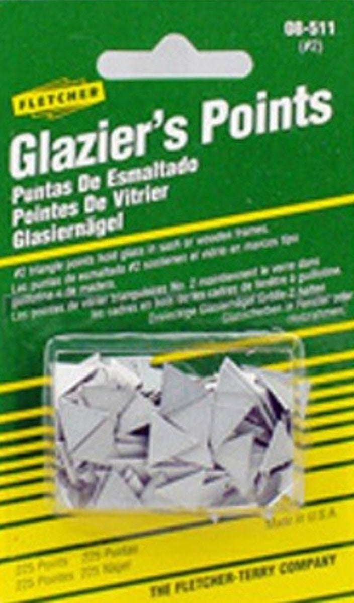 Small silver triangular metal points used for securing glass in home improvement projects and tools.