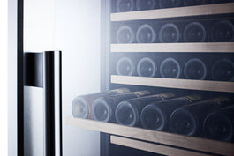 Luxury left-hinged wine cellar with wooden slide-out shelves storing Bordeaux bottles in modern kitchen appliance setting