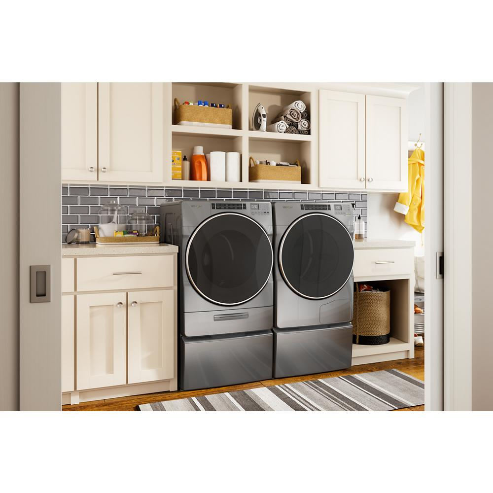 Modern laundry room with gray front load washer and dryer set elevated on pedestals with storage in appliances collection