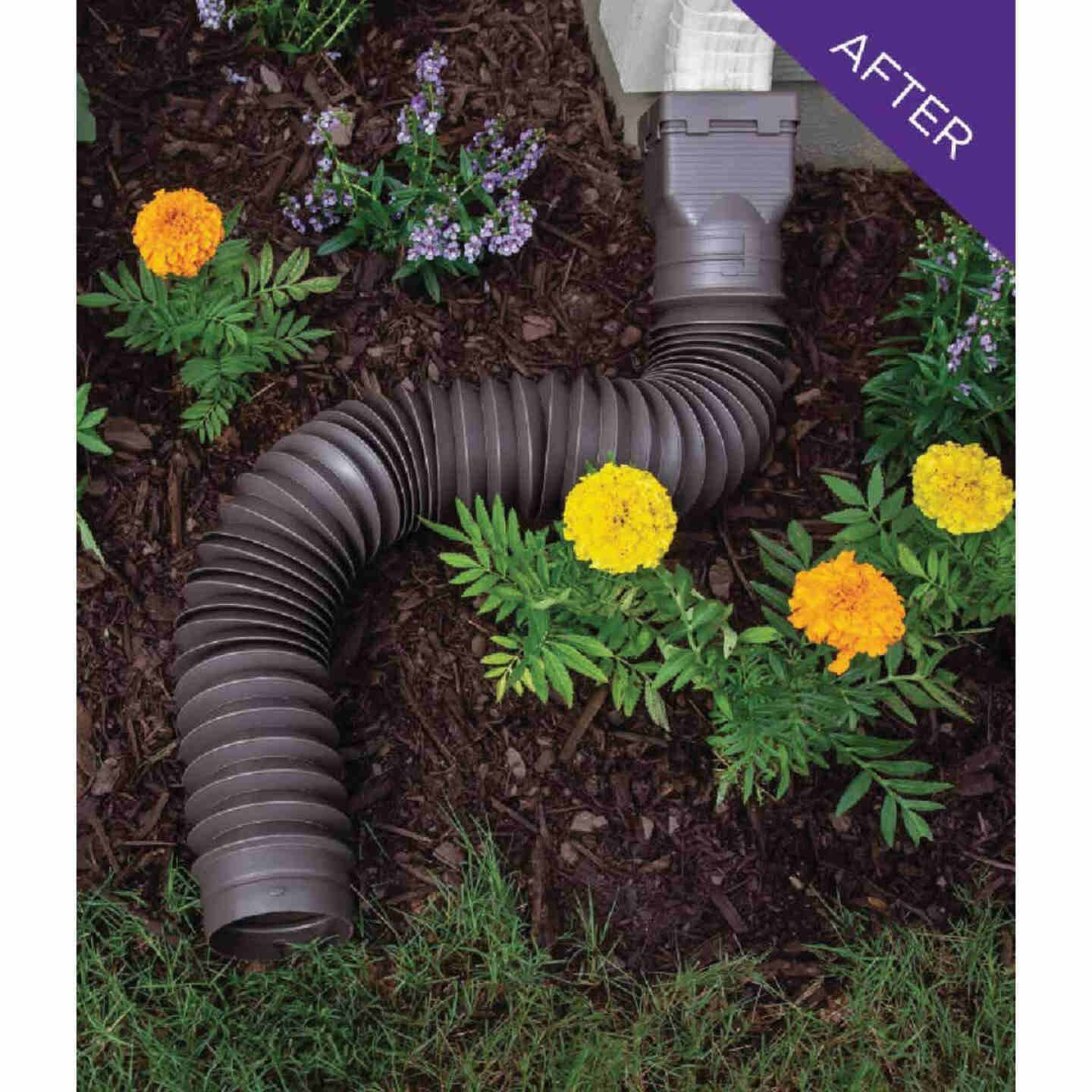 Brown flexible downspout extension installed directing water away from foundation for home improvement and water control