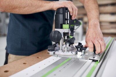 Festool woodworking router with guide stop accessory on track system for accurate cuts in home improvement projects