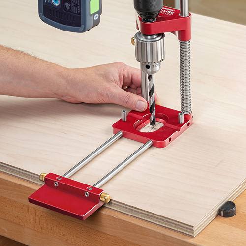 Red drill guide accessory with adjustable rods and clamp for precise drilling in power tool and drill attachments collections