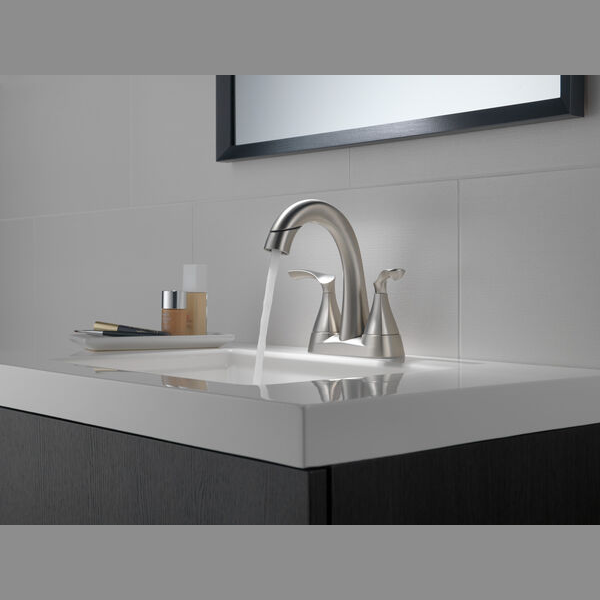 Brushed nickel two-handle centerset bathroom faucet with curved spout for bathroom sink plumbing and home improvement projects