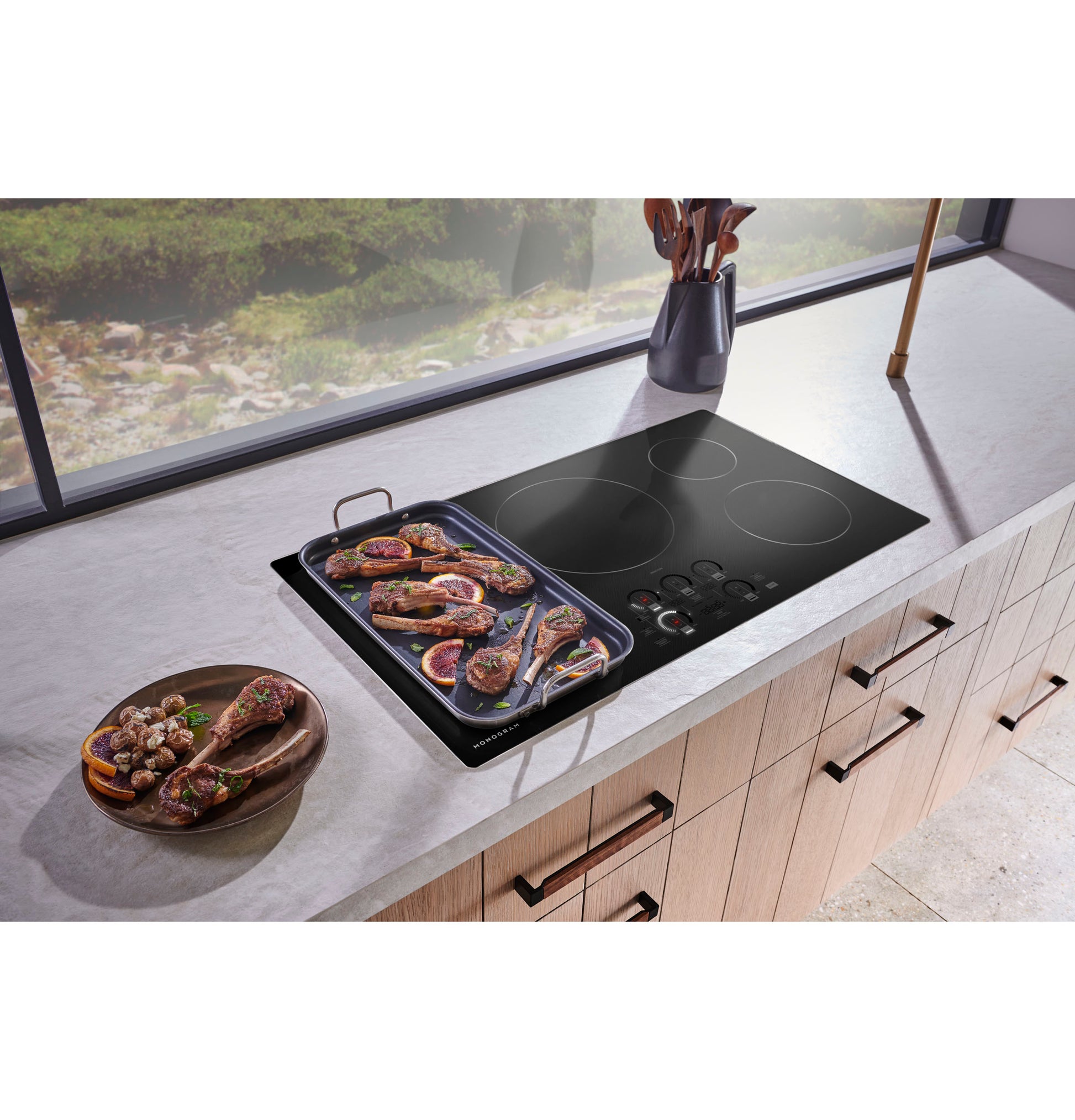Black glass induction cooktop with four cooking zones and digital touch controls in modern kitchen appliance setup