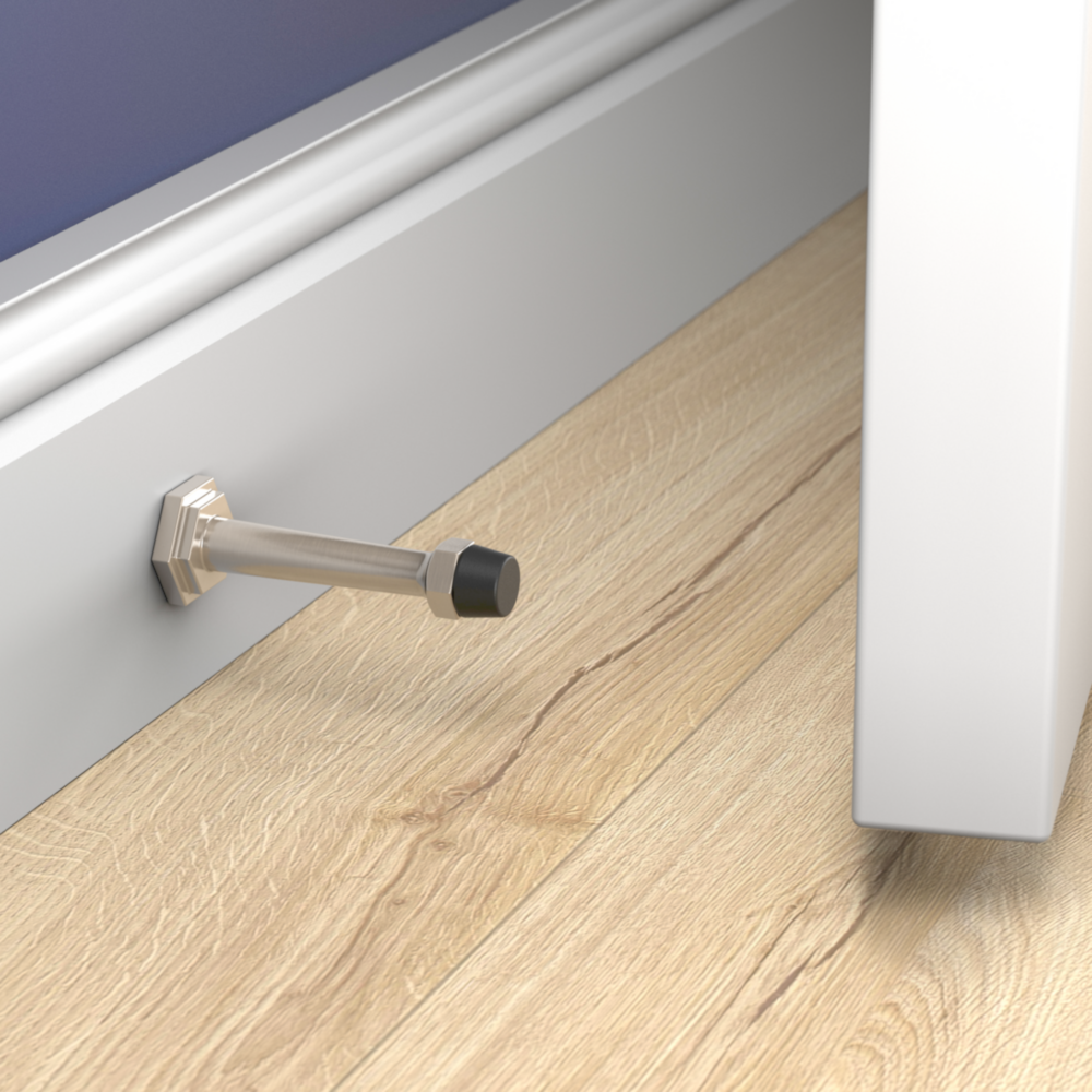Satin nickel wall-mounted door stop protecting painted white door and baseboard on hardwood floor for door accessories