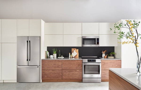 Modern kitchen featuring stainless steel appliances including Bosch refrigerator, oven, and built-in microwave in over the range microwaves collection