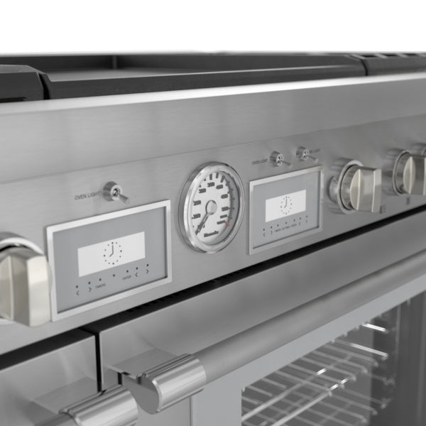 Close-up of stainless steel professional range controls featuring analog temperature gauge and digital timers in modern kitchenware collection