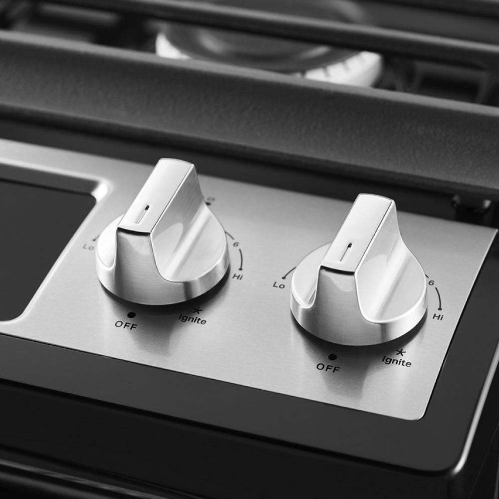 Close-up of stainless steel control knobs for gas burners on a Whirlpool range from Ranges & Kitchenware collection