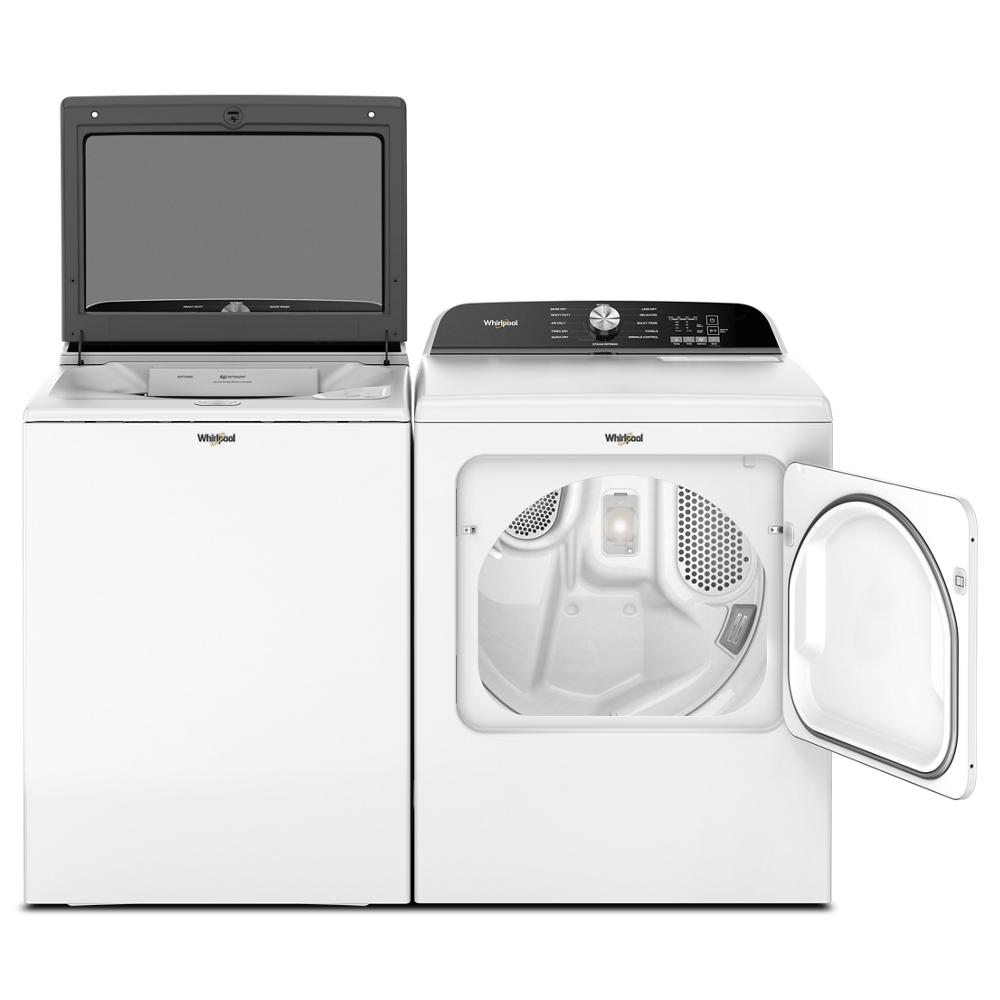 White Whirlpool top load washer with removable agitator next to front load dryer with open door in appliance collection