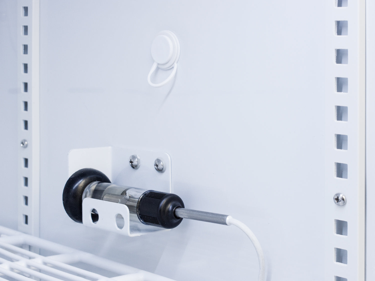 Close-up of temperature sensor probe installed inside an upright laboratory refrigerator in Appliances collection